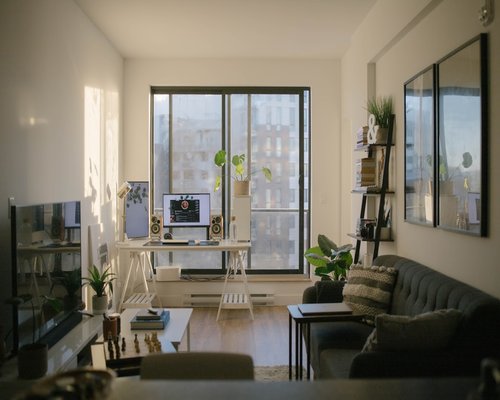 A desk next to a large window letting in natural daylight