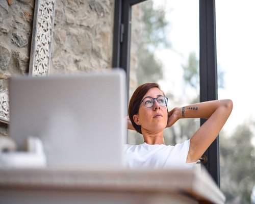 A person taking a break, looking away from a computer screen